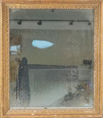 a reflection of a person in a mirror on the wall