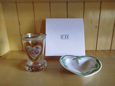 a heart shaped bowl and a glass on a table