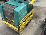 a green and yellow machine that is sitting on the ground