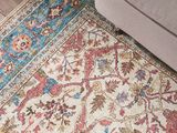 the area rug is on the floor next to a couch