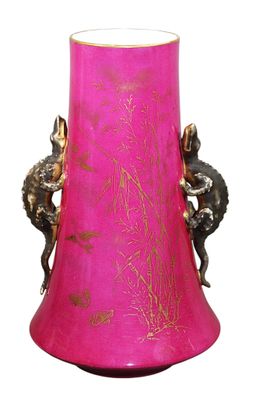 a pink vase with a gold design on it