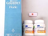 a box of gourmet perlex next to two bottles of gourmet perlex