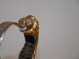 a close up of a ring with a lion head on it