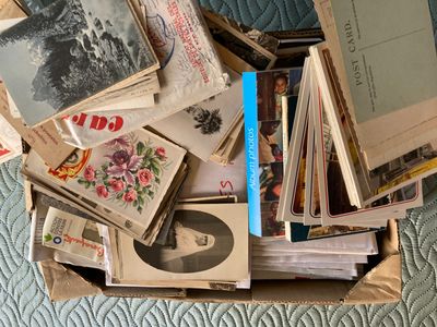 a box full of old books on a bed