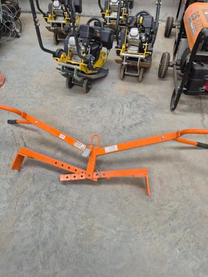 a man standing next to a group of lawn mowers in a garage