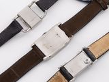 three different types of belts with a guitar pick on a white surface