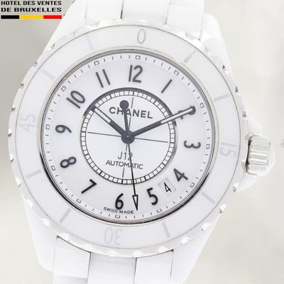 a white watch with black numbers on the face
