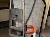 une image représentant un aspirateur et une échelle dans une salle de bains