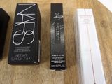 two boxes of makeup and a box of mascara on a table
