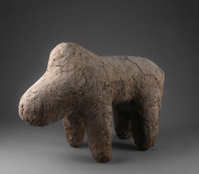 sculpture d'un ours en argile sur fond gris
