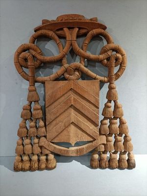 a wooden plaque with tassels hanging on the wall