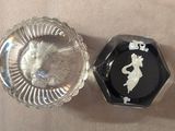 a glass ashtray and a glass ashtray on a table