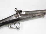 an old gun that is sitting on top of a table