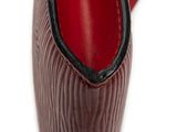 heel of a woman ' s shoe on a white surface with a red sole