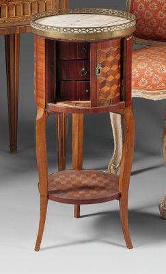 two chairs and a table in a room with a chair in the background