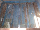 a dirty blue truck bed with rust on it