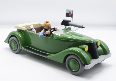 a green toy car with a man sitting in it