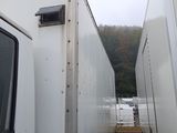 a picture of a couple of white trucks parked in a parking lot