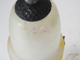 a white bottle with a black top sitting on a table
