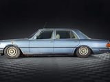 a blue car that is sitting on a black and white checkered floor