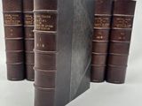 three books are stacked on top of each other on a white surface