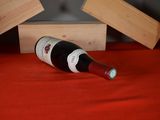 a bottle of wine sitting on a table next to two wooden blocks