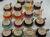 many cups and saucers that are sitting on a table