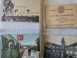 several old postcards are displayed on a white table cloth