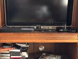 a television that is sitting on top of a book shelf