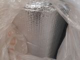 a silver vase wrapped in plastic and wrapped in plastic