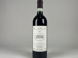 the bottle of red wine is sitting on the table