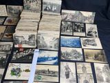 a lot of old postcards sitting on a table