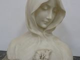 marble bust of a woman with a hood over her head and a flower in her hair