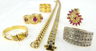 a close up of a bunch of jewelry on a white surface