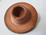 a brown candle holder sitting on a white table