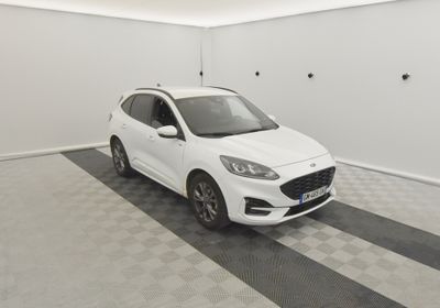 une voiture blanche garée dans un garage au sol en damier