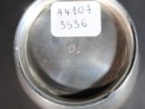 a close up of a silver vase with a label on it