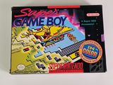 the box of the gameboy is sitting on a white surface