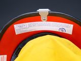 a close up of a yellow hat with a red visor