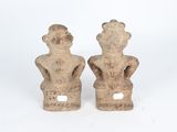 pair of stone figurines of a man and a woman