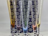 four wine glasses are lined up in a row in front of a box