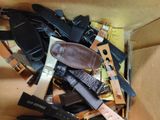 a cardboard box filled with lots of different types of watches
