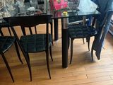 a glass dining table with black chairs in a room