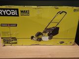 a box of a lawn mower sitting on top of a wooden table