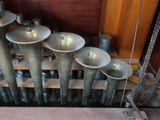 a bunch of metal pipes that are sitting on a shelf