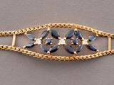 gold - plated bracelet with a faceted blue topaz stone
