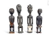three wooden figurines of different shapes and sizes on a white surface