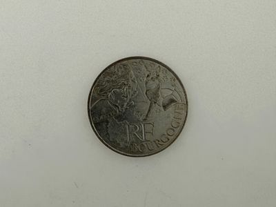 an image of a small coin on a white surface