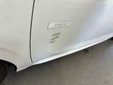 a close up of a white car with a sticker on it