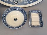 a blue and white plate, bowl, and tray sitting on a table